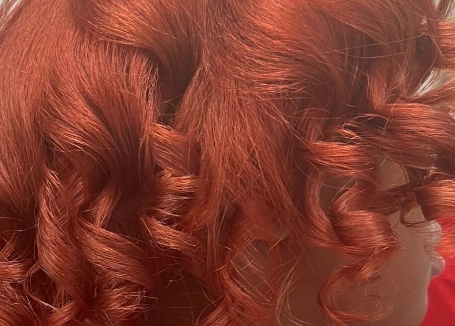 Vibrant red curls styled at Tasja’s Style Studio in Madison, Wisconsin, US.
