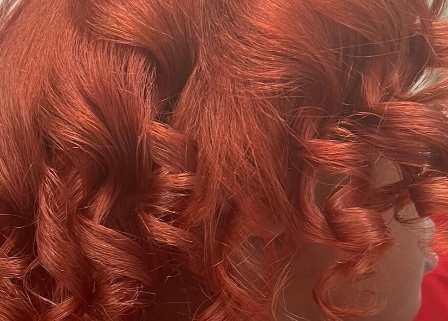 Vibrant red curls styled at Tasja’s Style Studio in Madison, Wisconsin, US.