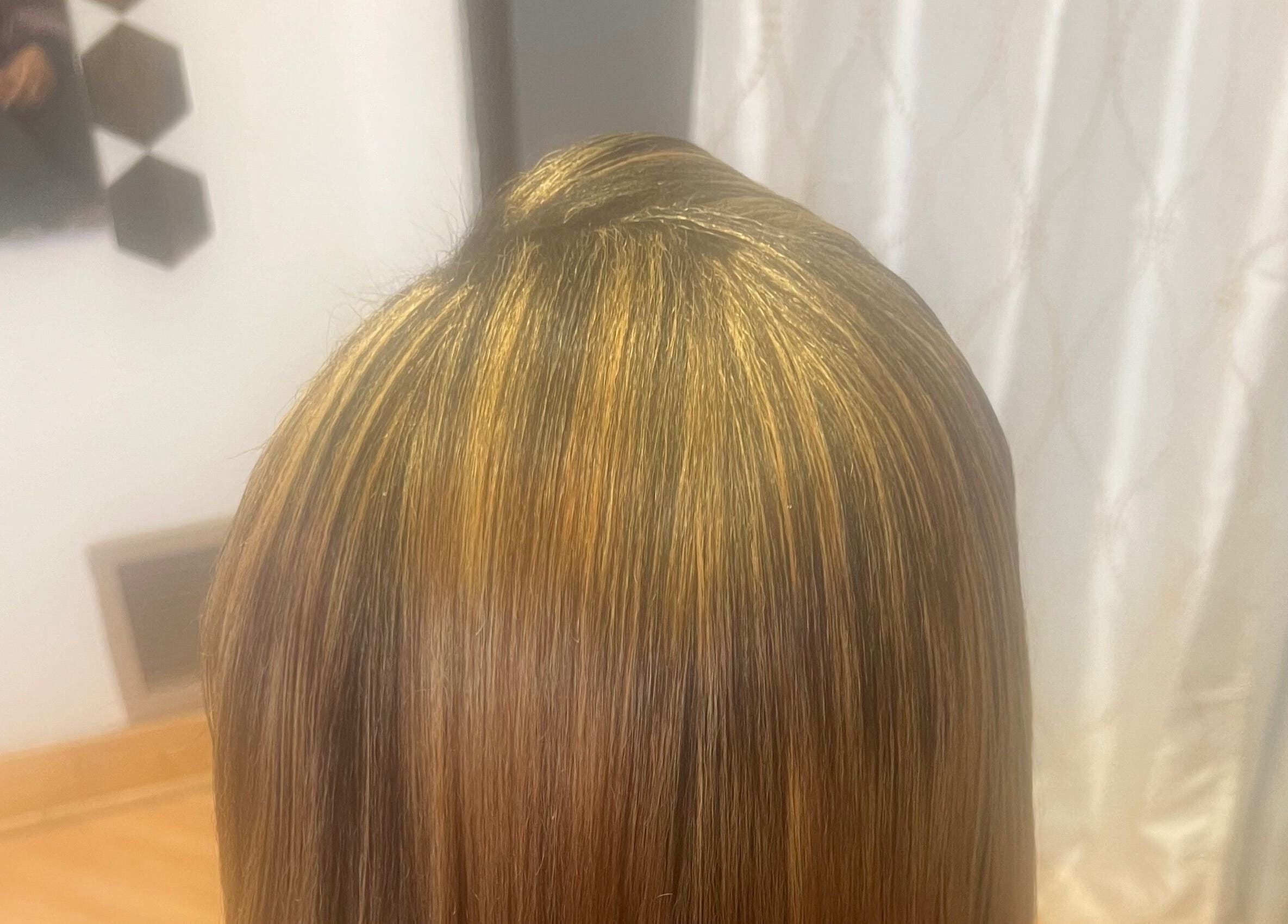 Elegant smooth hairstyle at Tasja’s Style Studio in Madison, Wisconsin, US showcasing golden highlights.