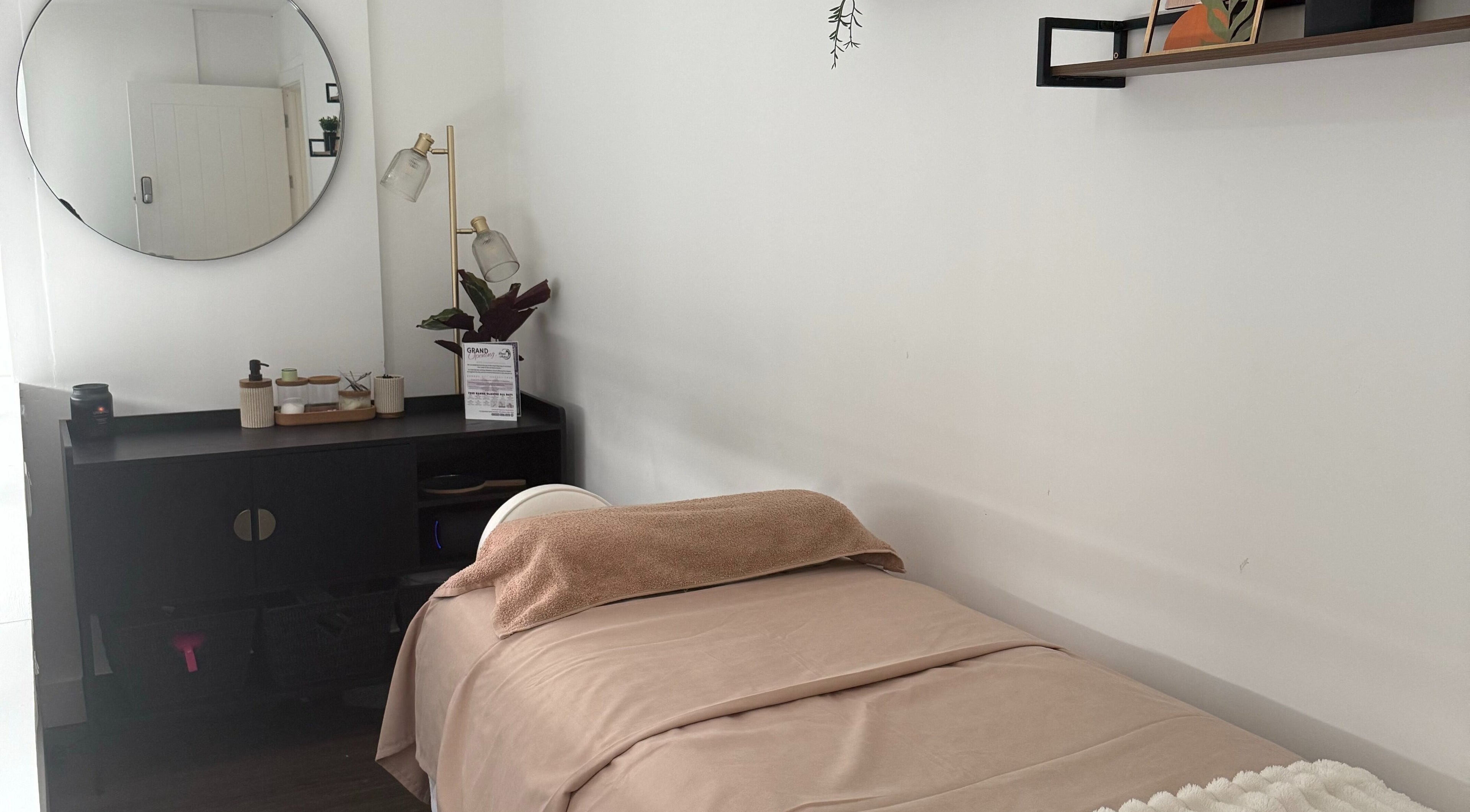 Tranquil spa room at Beauty by González, West Bridgford, England, GB with a treatment bed and elegant decor.
