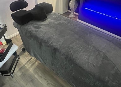 Relax in the treatment room at Glo Luxe Studios, Crowborough, England, GB. Featuring a plush table and soothing lights.