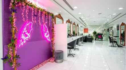 Modern salon interior at Ambra Beauty, Abu Dhabi, AE with neon accents and elegant decor.