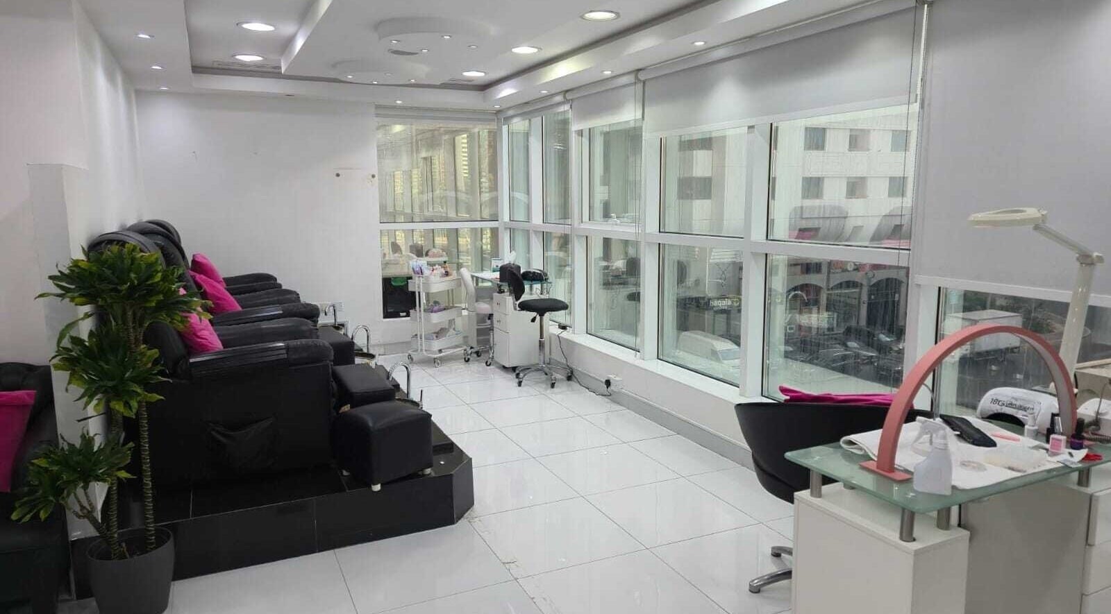 Relaxing spa seating area at Ambra Beauty, Abu Dhabi, AE, with sleek chairs and bright natural lighting.