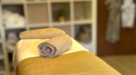 Calming spa room at Maiskin, Dublin, County Dublin, IE, featuring a neatly prepared massage table.
