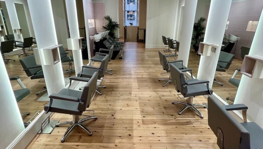 Modern salon interior at Erin Hunt Hairdressing, Edinburgh, Scotland, GB, showcasing sleek styling chairs and mirrors.