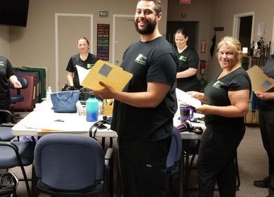 Staff at Body in Mind Massage Institute - Toms River in Toms River, New Jersey, US engaged in a team meeting.