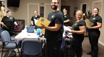 Staff at Body in Mind Massage Institute - Toms River in Toms River, New Jersey, US engaged in a team meeting.