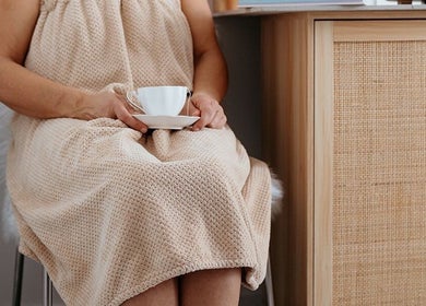 Client enjoying tea at Flourish Skin & Beauty, Wānaka, Otago, NZ, promoting relaxation and pampering.