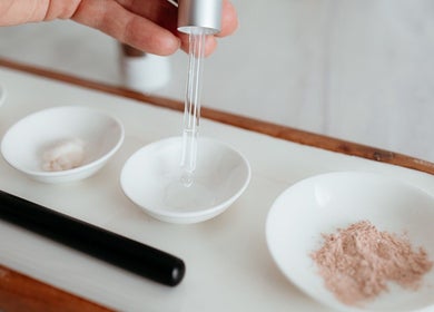 Skincare products in white bowls at Flourish Skin & Beauty, Wānaka, Otago, NZ, showcasing beauty essentials.