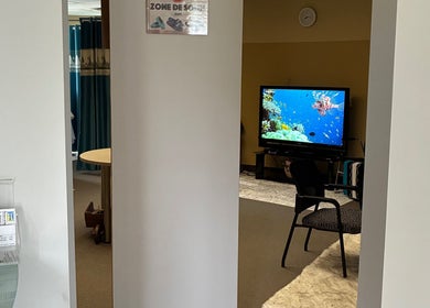 Intérieur de Clinique MEDS à Saint-jean-de-matha, Québec, CA, avec TV diffusant des images sereines.