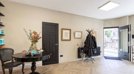 Stijlvolle ingang bij Salon Zuid, Amsterdam, Noord-Holland, NL met elegante decoraties en meubels.