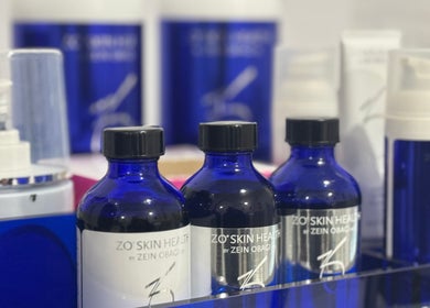 Luxury skincare products at La Maison Beauté, Melbourne, Victoria, AU, showcasing blue bottles and treatments.