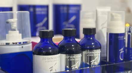 Luxury skincare products at La Maison Beauté, Melbourne, Victoria, AU, showcasing blue bottles and treatments.