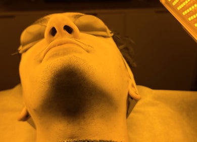 Person under LED therapy at La Maison Beauté, Melbourne, Victoria, AU for rejuvenating skin care.