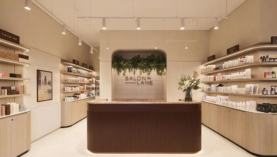 Elegant salon entry at Aidan Gardner Hair, Bondi Junction, showcasing products and decor.
