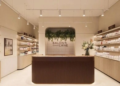 Elegant salon entry at Aidan Gardner Hair, Bondi Junction, showcasing products and decor.