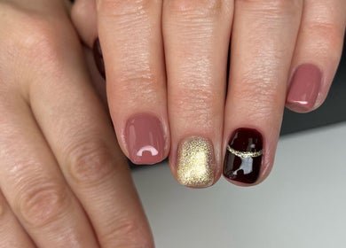 Stylish manicure at The Nail Place, Coachford, County Cork, IE with pink, gold, and dark polish.