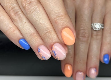 Colorful nail art at The Nail Place, Coachford, County Cork, IE showcasing blue and orange designs.