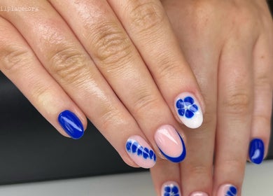 Blue floral nails at The Nail Place, Coachford, County Cork, IE showcase vibrant elegance.