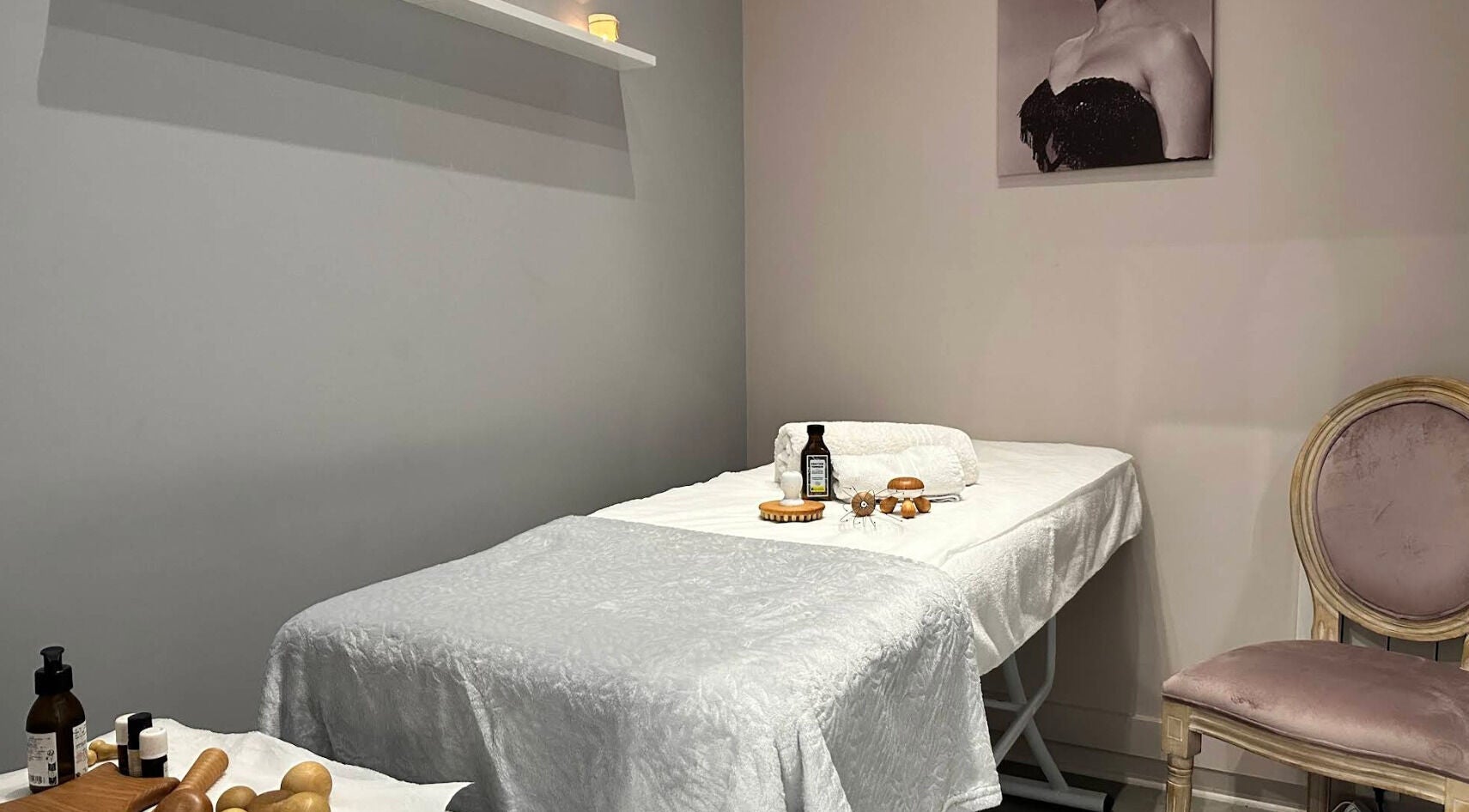Tranquil treatment room at Institut Caramel Paris, Paris, Île-de-france, FR, featuring a massage bed and products.