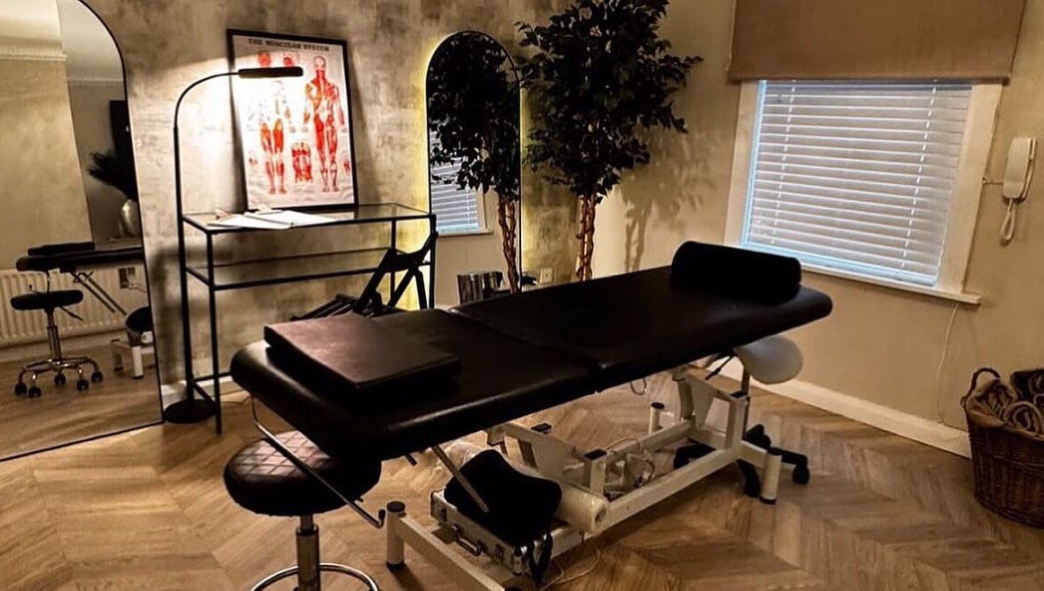 Treatment room at By Ellie Aesthetics in Liverpool, England, GB, featuring a massage table and elegant decor.