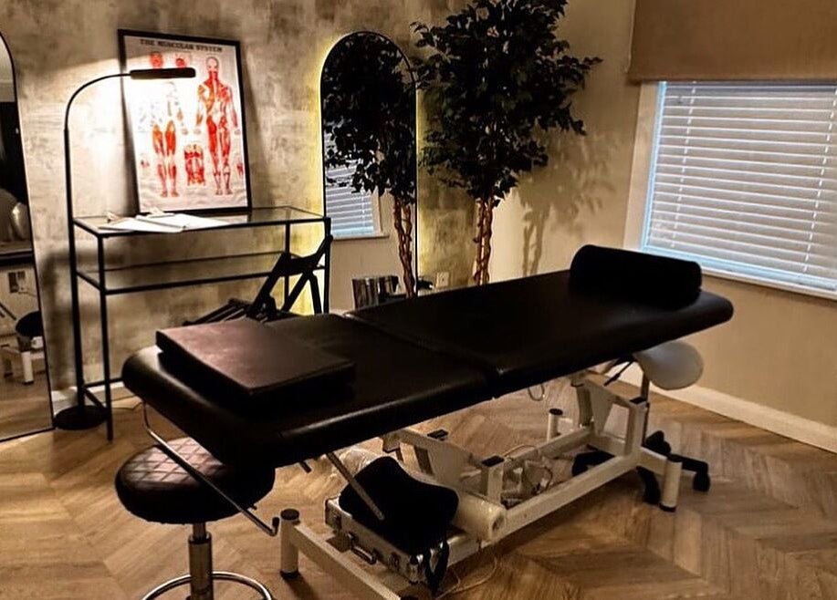 Treatment room at By Ellie Aesthetics in Liverpool, England, GB, featuring a massage table and elegant decor.