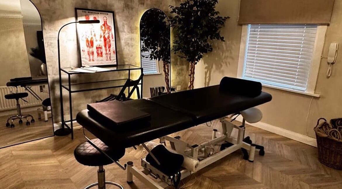 Treatment room at By Ellie Aesthetics in Liverpool, England, GB, featuring a massage table and elegant decor.