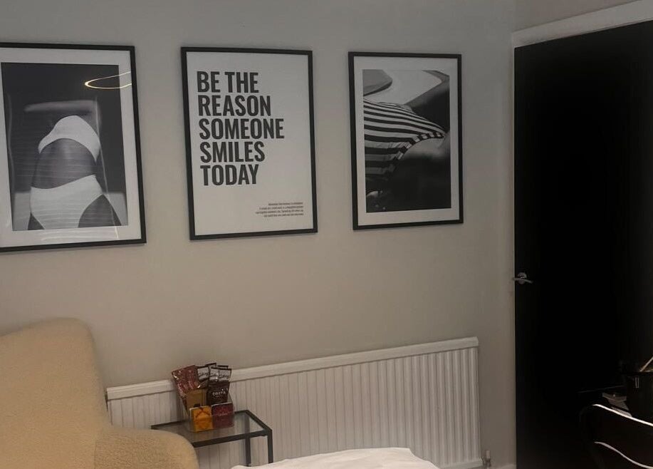 Elegant lounge at By Ellie Aesthetics, Liverpool, England, GB, with inspirational artwork and cozy seating.