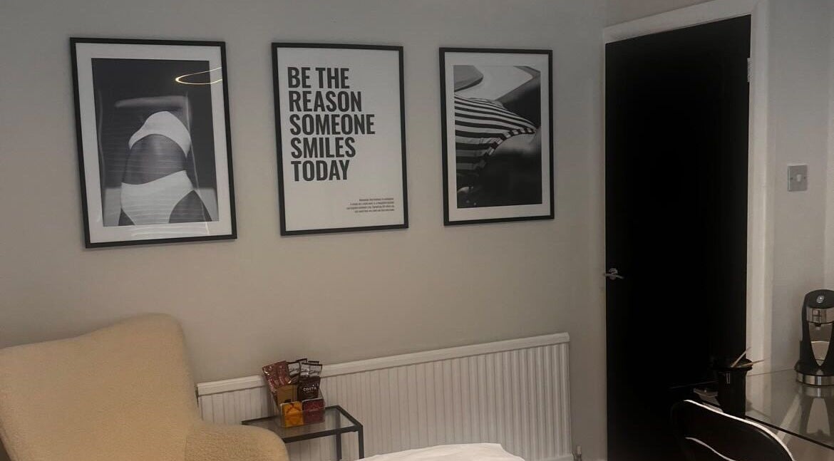 Elegant lounge at By Ellie Aesthetics, Liverpool, England, GB, with inspirational artwork and cozy seating.