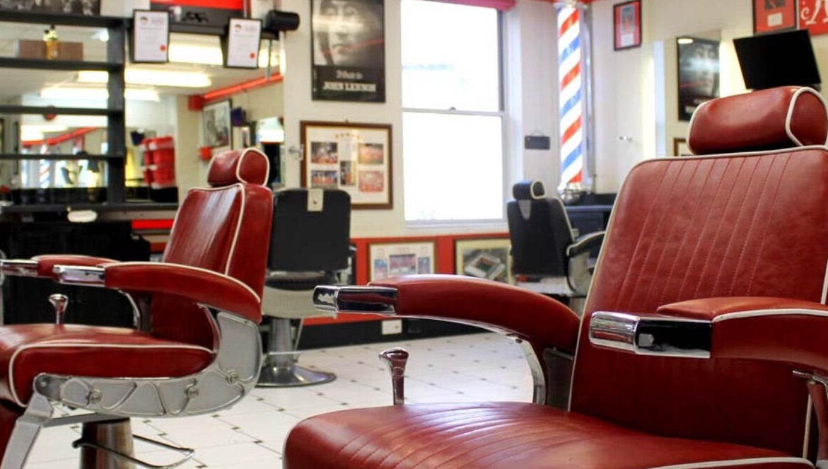 Vintage red barber chairs at Image Barbers in Saint Helier, St Helier, JE, showcasing a classic retro vibe.