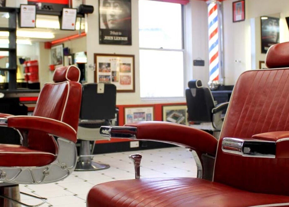 Vintage red barber chairs at Image Barbers in Saint Helier, St Helier, JE, showcasing a classic retro vibe.