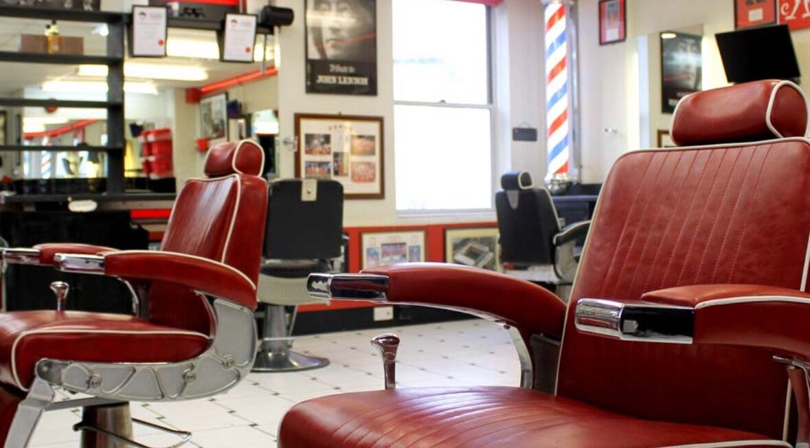 Vintage red barber chairs at Image Barbers in Saint Helier, St Helier, JE, showcasing a classic retro vibe.