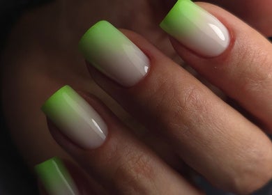 Stylish green-tipped nails at Italmas Nails Inc., New York, New York, US showcase trendy nail art.