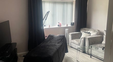 Cozy treatment area at Lashes After Hours, Sheffield, England, GB, with stylish seating and soothing decor.