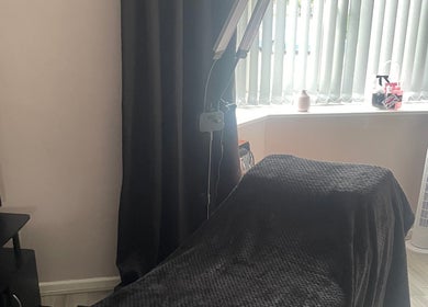 Cozy treatment room at Lashes After Hours in Sheffield, England, GB, featuring a massage table and soft lighting.