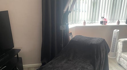 Cozy treatment room at Lashes After Hours in Sheffield, England, GB, featuring a massage table and soft lighting.