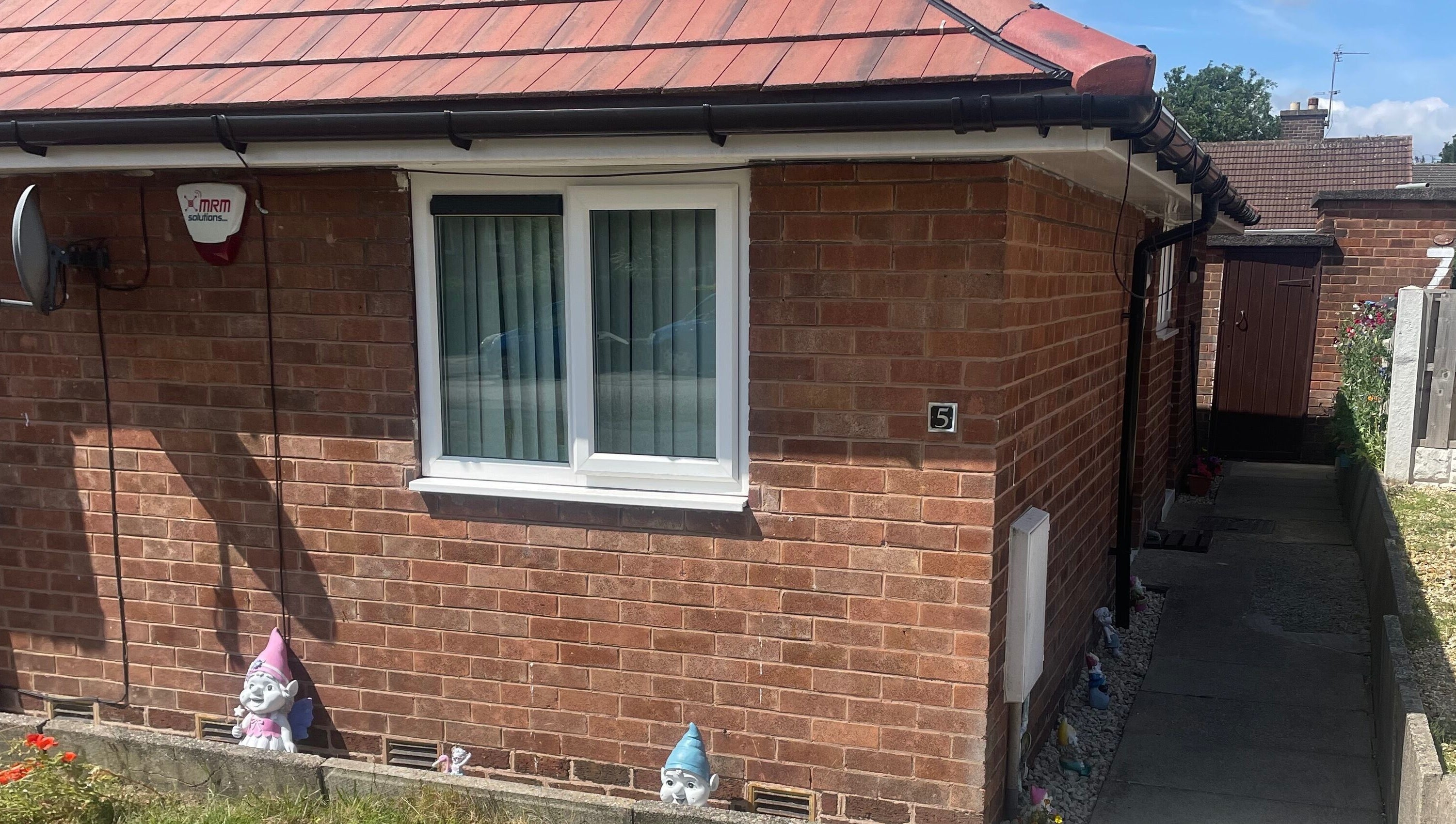 Front view of Lashes After Hours, a beauty venue in Sheffield, England, GB with brick walls and garden gnomes.