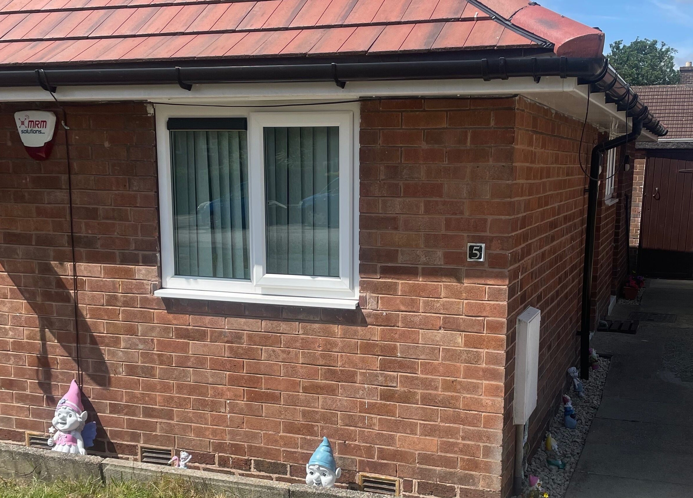 Front view of Lashes After Hours, a beauty venue in Sheffield, England, GB with brick walls and garden gnomes.