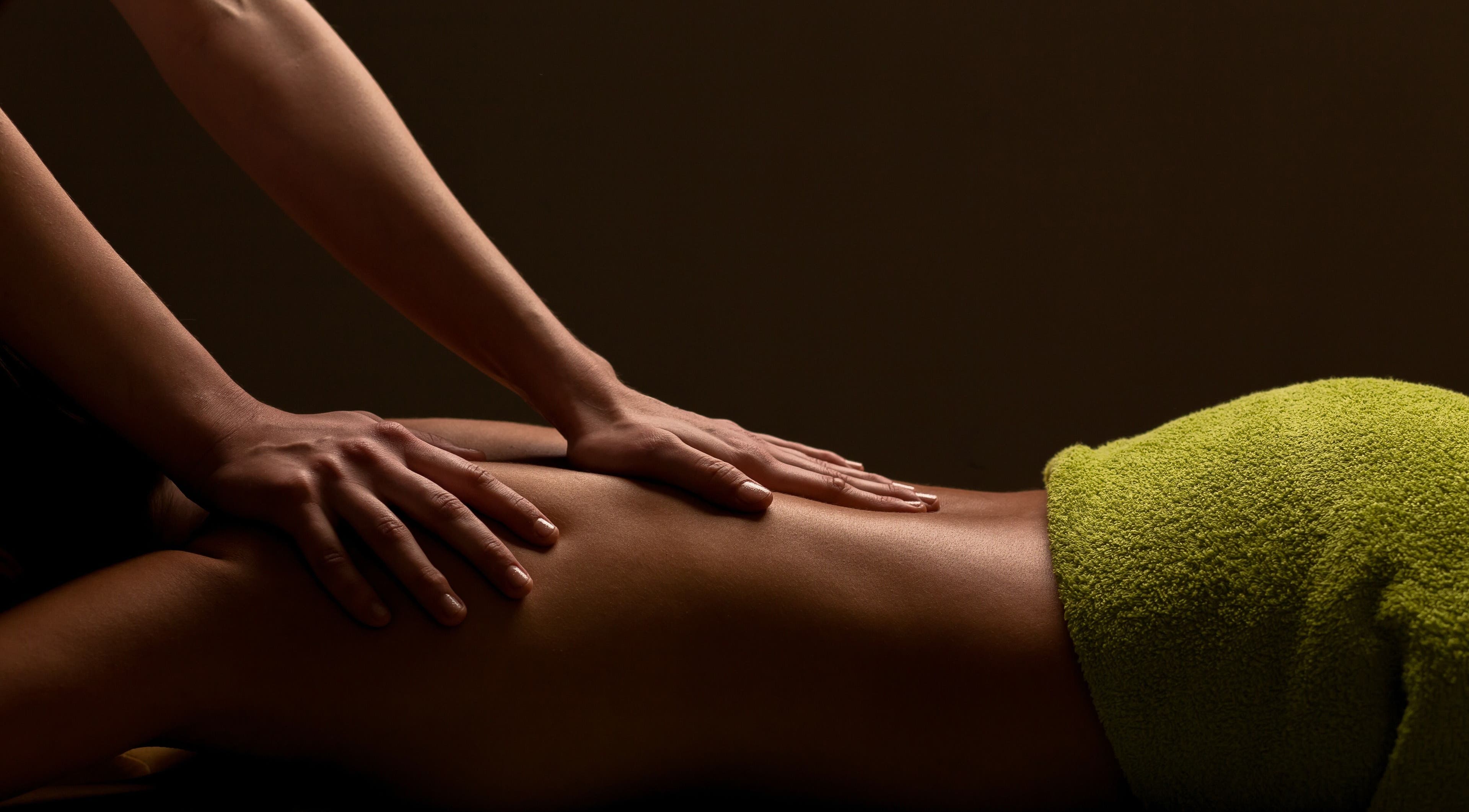 Massage therapy at 'T issue in Geneva, Illinois, US, showing a relaxing back massage session.