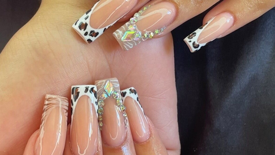 Leopard and gem-accented nails at Polished By Kirsty in Gqeberha, Eastern Cape, ZA showcasing elegant design.