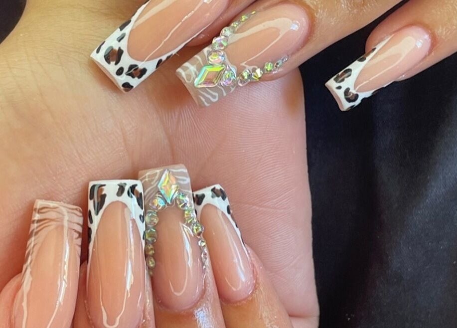 Leopard and gem-accented nails at Polished By Kirsty in Gqeberha, Eastern Cape, ZA showcasing elegant design.