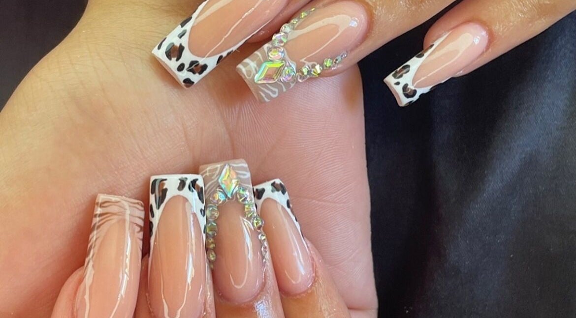 Leopard and gem-accented nails at Polished By Kirsty in Gqeberha, Eastern Cape, ZA showcasing elegant design.