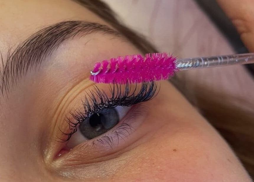 Close-up of lash treatment at Polished By Kirsty, Gqeberha, Eastern Cape, ZA using a pink brush.