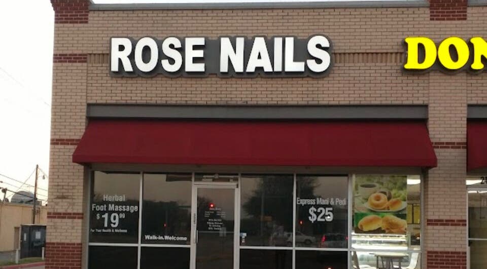 Front view of Rose Nails salon in Lewisville, Texas, US with red awning and signage displaying services.