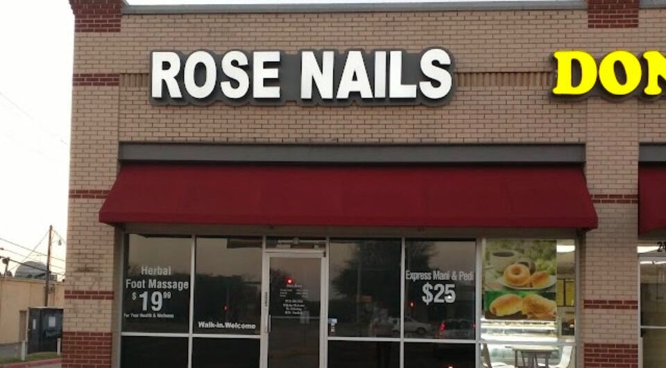 Front view of Rose Nails salon in Lewisville, Texas, US with red awning and signage displaying services.