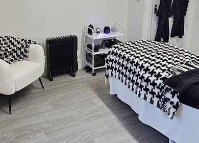 Cozy treatment room at Aura 8 Mcr, Prestwich, England, GB, featuring stylish decor and inviting ambiance.