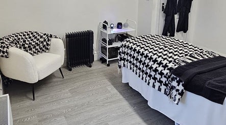 Cozy treatment room at Aura 8 Mcr, Prestwich, England, GB, featuring stylish decor and inviting ambiance.