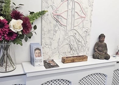 Aura 8 Mcr in Prestwich, England, GB: elegant Buddha statue and floral decor on a white mantle.