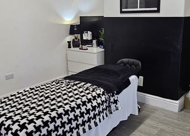 Relaxing treatment room at Aura 8 Mcr, Prestwich, England, GB. Elegant black and white decor.