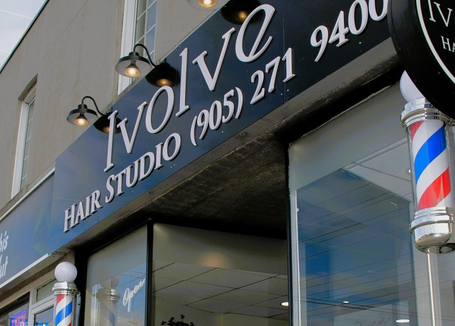 Ivolve Hair Studio entrance in Mississauga, Ontario with vibrant signage and barber pole.